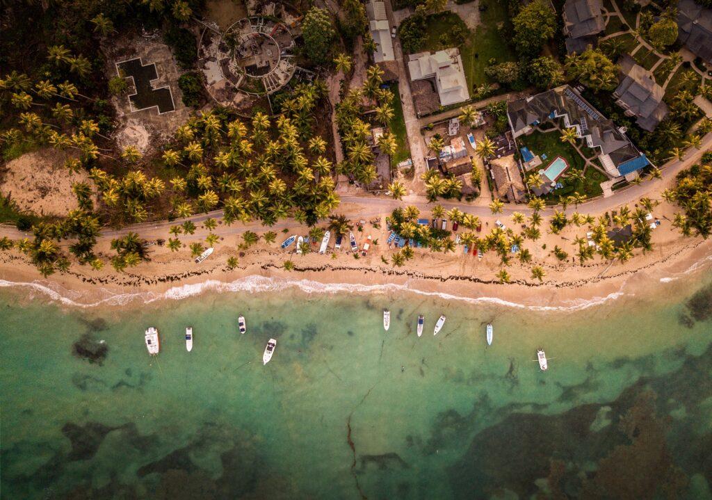 shot of houses and small boats parked near the seashore